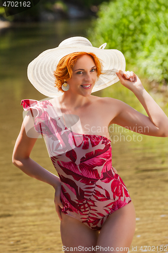 Image of Sexy redhead in a swimsuit