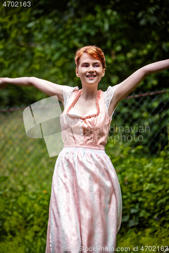 Image of Happy young woman in a dirndl