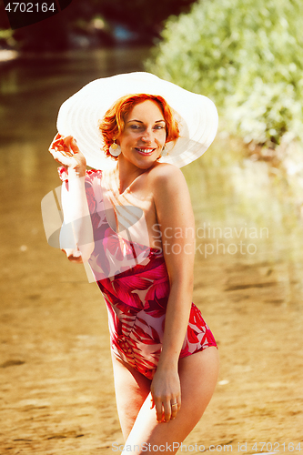 Image of Portrait of a redheaded woman in a swimsuit