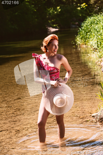 Image of Woman in swimsuit and red hair