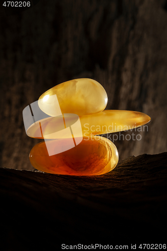 Image of Beauty of natural amber. Three pieces of yellow natural amber on top of each other.