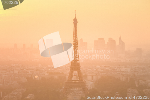 Image of Aerial view of Paris with Eiffel tower and major business district of La Defence in background at sunset