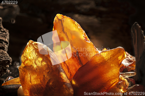 Image of Beauty of natural amber. Several yellow natural amber stones in a cave.