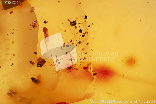 Image of Natural amber texture. Yellow opaque natural amber with layers.