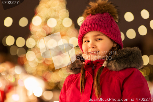 Image of happy little girl at christmas market in winter