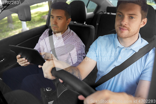 Image of car driving school instructor and young driver