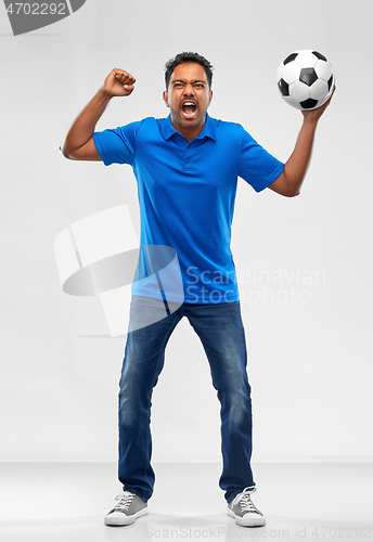 Image of angry indian male football fan with soccer ball