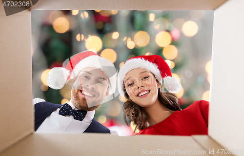 Image of happy couple opening christmas gift box