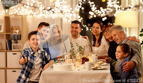 Image of family having birthday party and taking selfie