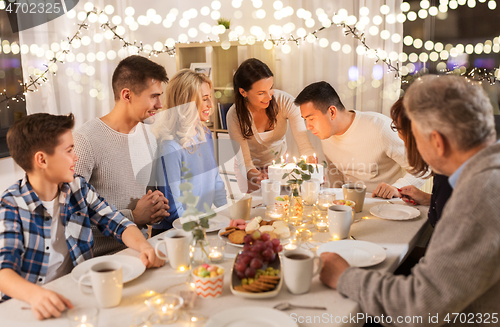 Image of happy family having birthday party at home