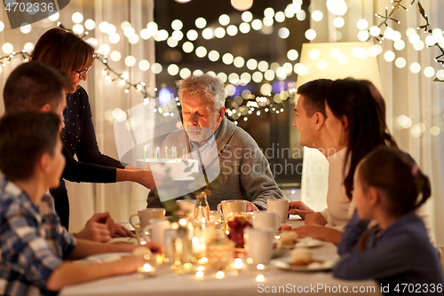 Image of happy family having birthday party at home