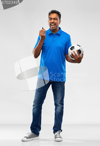 Image of indian football coach with soccer ball and whistle