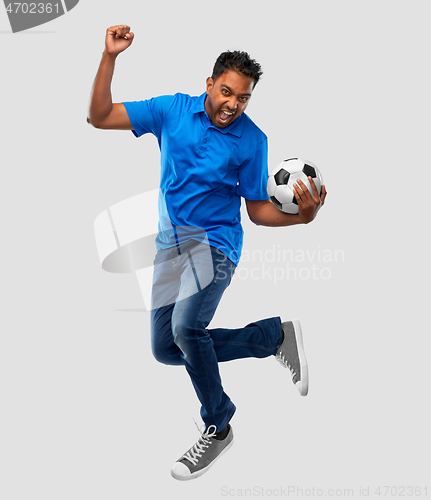 Image of man or football fan with soccer ball jumping