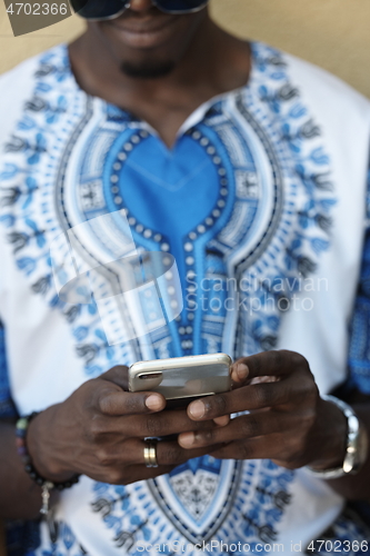 Image of native african black man using smart phone