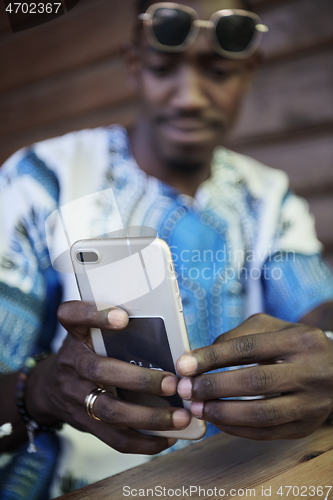 Image of native african black man using smart phone