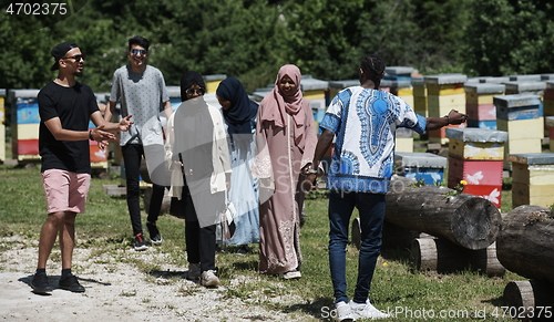 Image of people group visiting local honey production farm