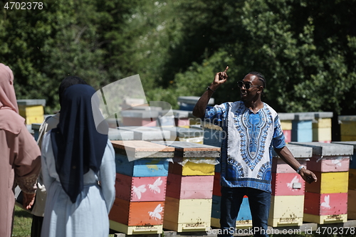 Image of people group visiting local honey production farm