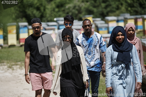 Image of people group visiting local honey production farm