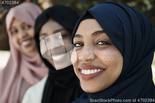 Image of businesswoman group portrait wearing traditional islamic clothes