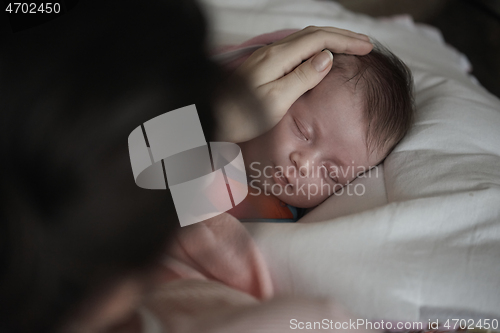 Image of new born baby sleeping and in dreams smillling