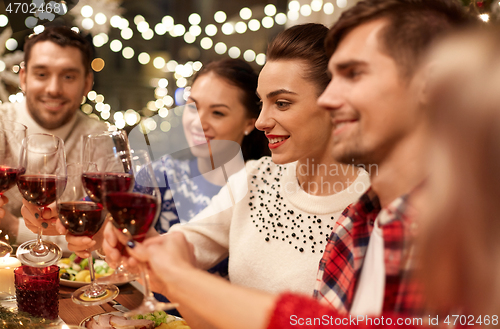 Image of friends celebrating christmas and drinking wine