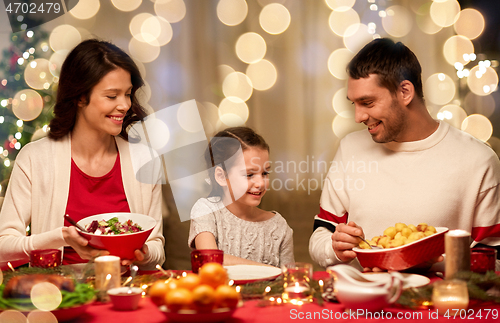 Image of happy family having christmas dinner at home