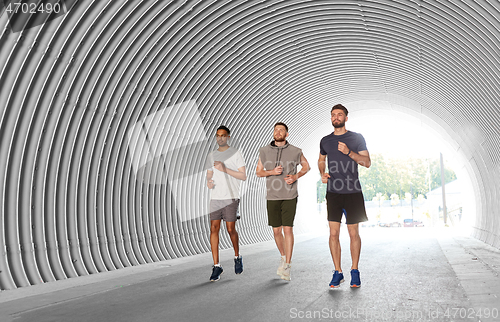 Image of young men or male friends running outdoors