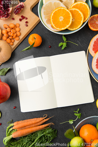 Image of close up of notebook, fruits and vegetables