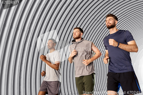 Image of young men or male friends running outdoors