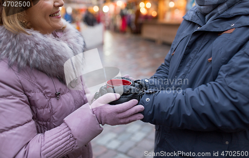 Image of senior couple with mulled wine at christmas market