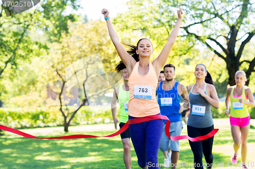 Image of happy young female runner on finish winning race