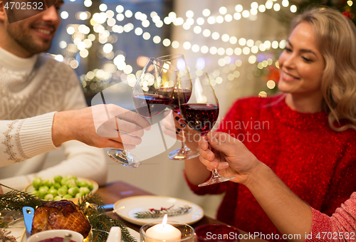 Image of close up of friends with wine celebrate christmas