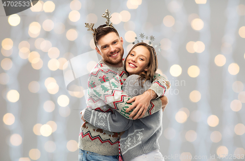 Image of happy couple at christmas ugly sweater party