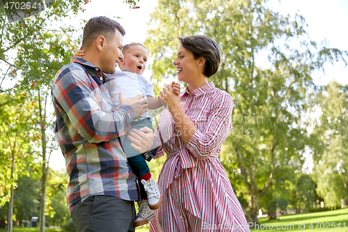 Image of happy family having fun at summer park