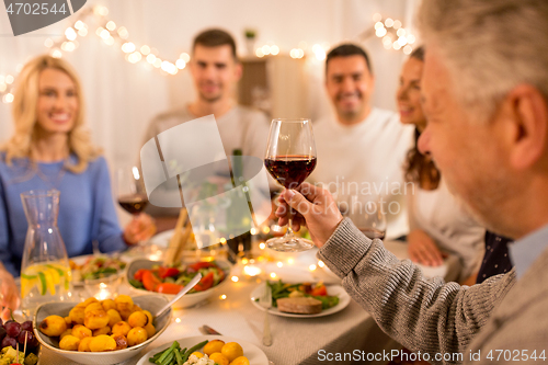 Image of happy family having dinner party at home