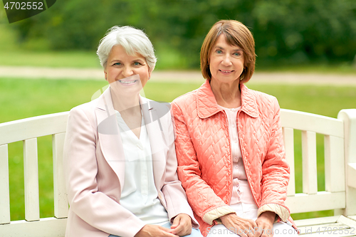 Image of senior women or friends sitting on bench at park