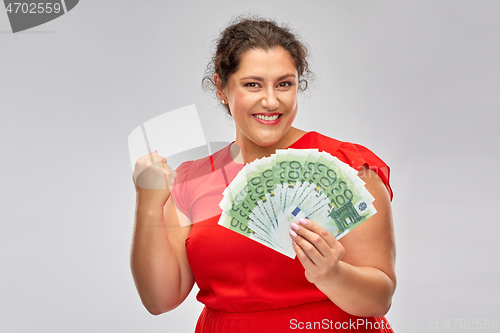 Image of happy woman holding hundreds of money banknotes