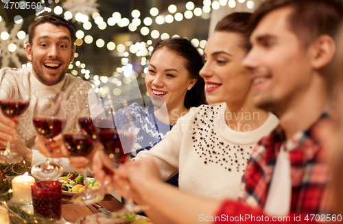 Image of friends celebrating christmas and drinking wine