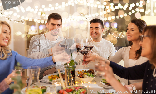 Image of happy family having dinner party at home