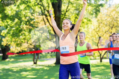 Image of happy young female runner on finish winning race