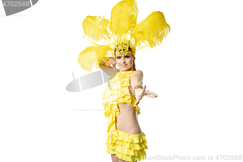 Image of Beautiful young woman in carnival, stylish masquerade costume with feathers dancing on white studio background.