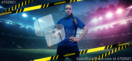 Image of Football or soccer player on stadium background behind limiting tapes with word Lockdown