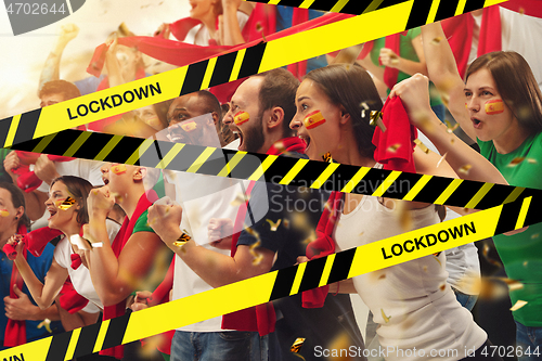 Image of Female and male soccer fans cheering for favourite sport team with bright emotions, excited, wondered behind the limiting tapes with Lockdown