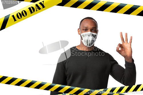 Image of Man wearing protective face mask with sign masks for 100 days in USA, America