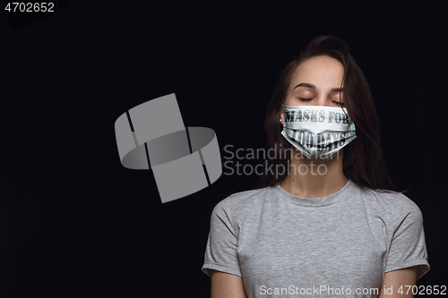 Image of Woman wearing protective face mask with sign masks for 100 days in USA, America