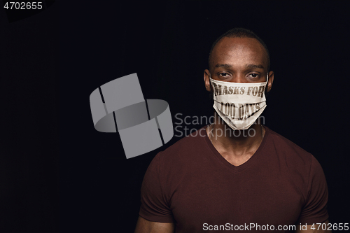 Image of Man wearing protective face mask with sign masks for 100 days in USA, America