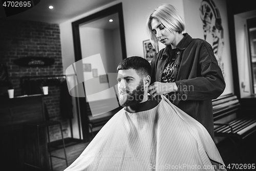 Image of Client during beard shaving in barber shop