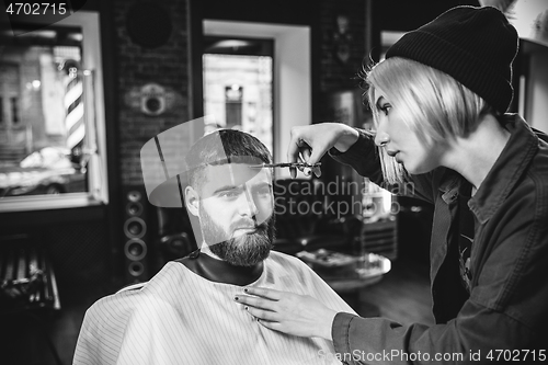 Image of Client during beard shaving in barber shop