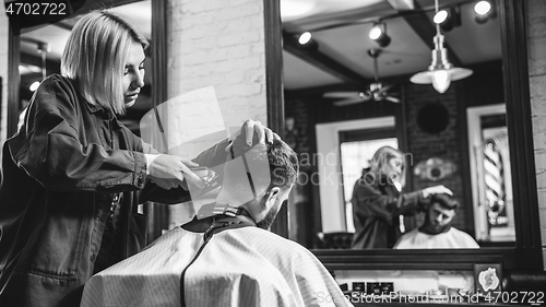 Image of Client during beard shaving in barber shop