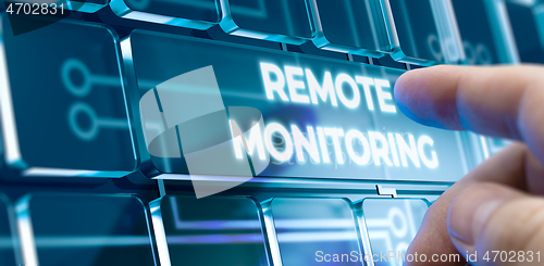 Image of Remote Monitoring - Man Pushing Button on Futuristic Interface.